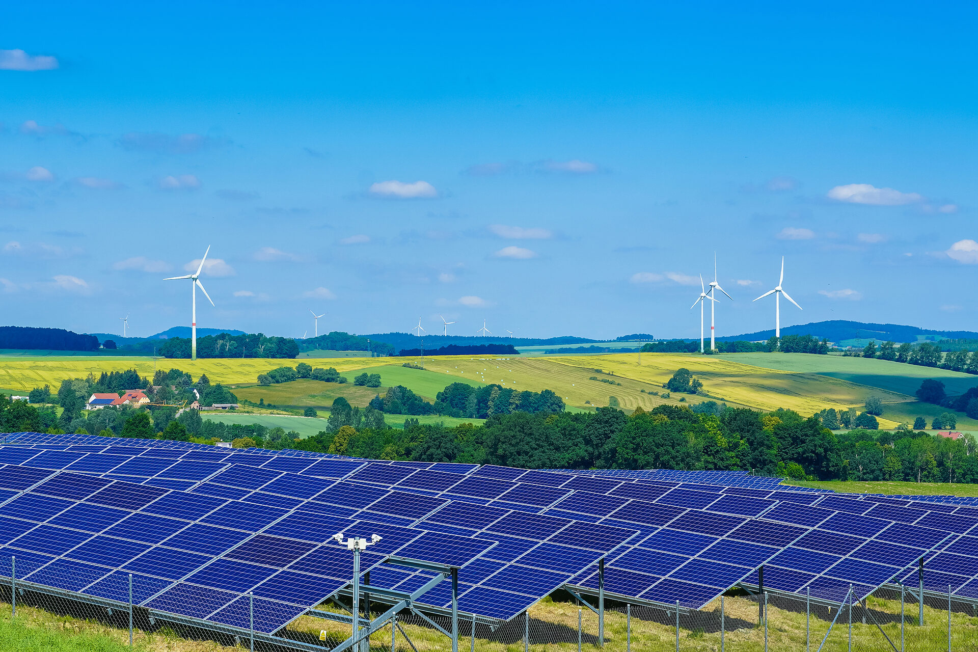 Agri-Photovoltaik, Windenergieanlagen und hügelige Landschaft mit Feldern